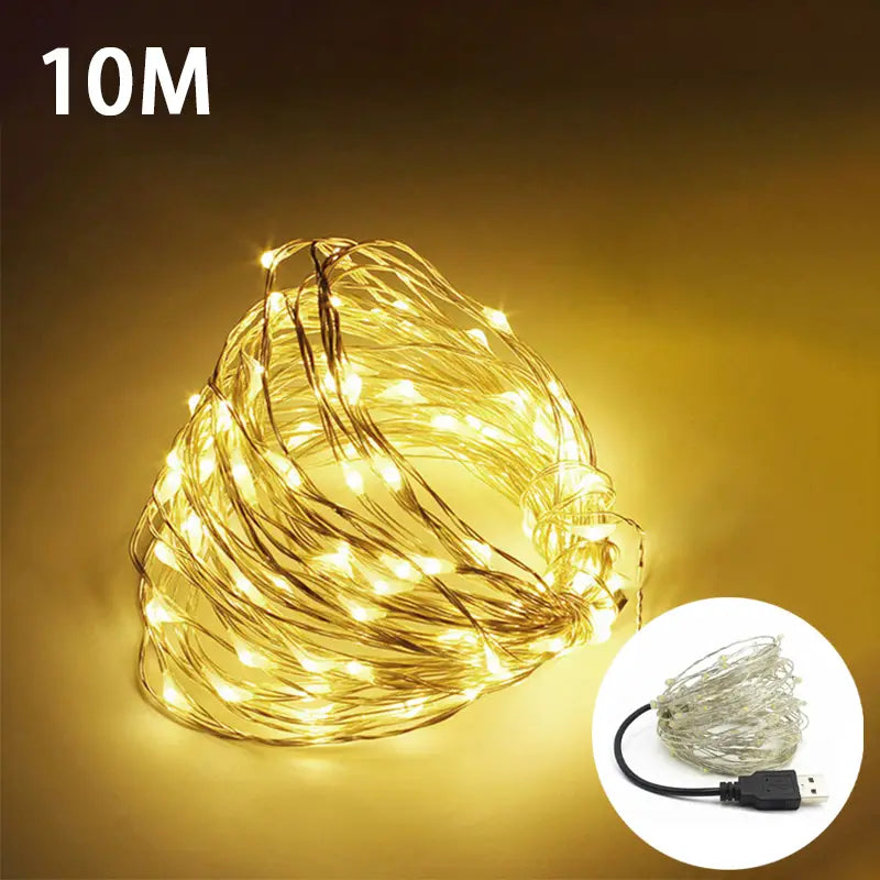 Warm white fairy lights draped on a bed